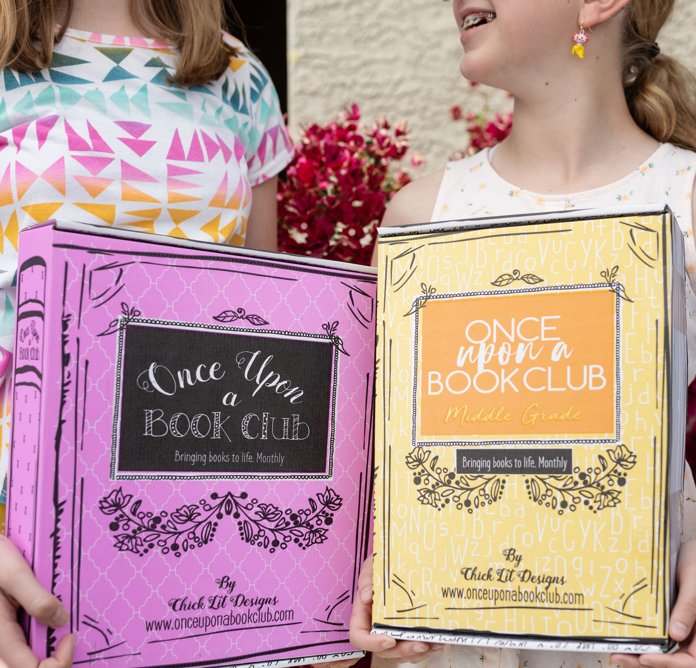 Two tween girls holding Middle Grade Book Boxes