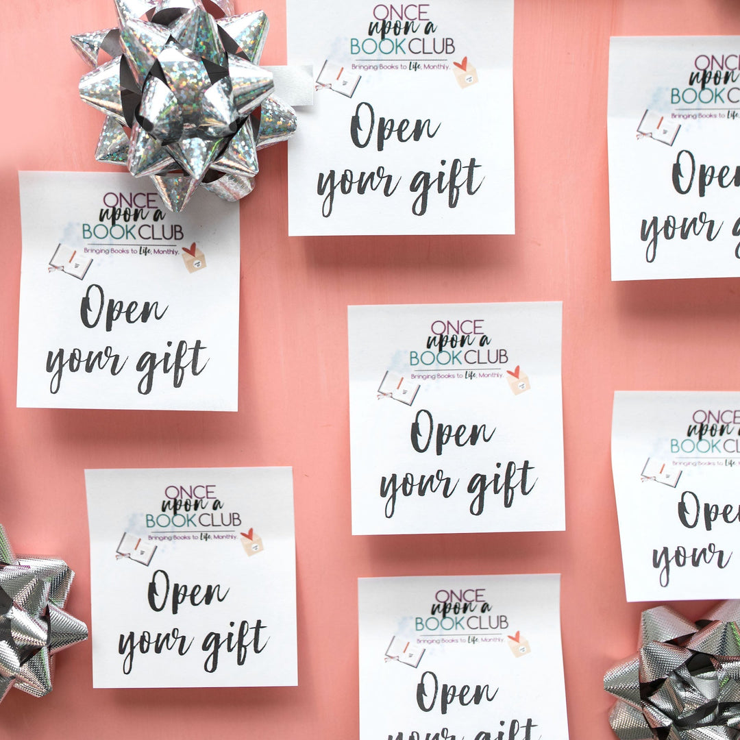 Open your gift sticky notes and silver bows sit on a coral background.
