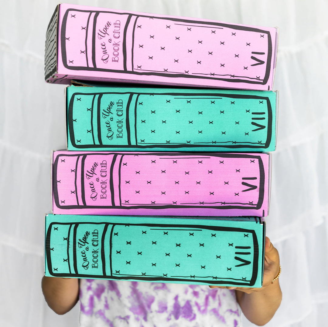 Four stacked pastel-colored boxes, alternating pink and teal, designed to look like book spines labeled VI and VII, held by an unseen person.