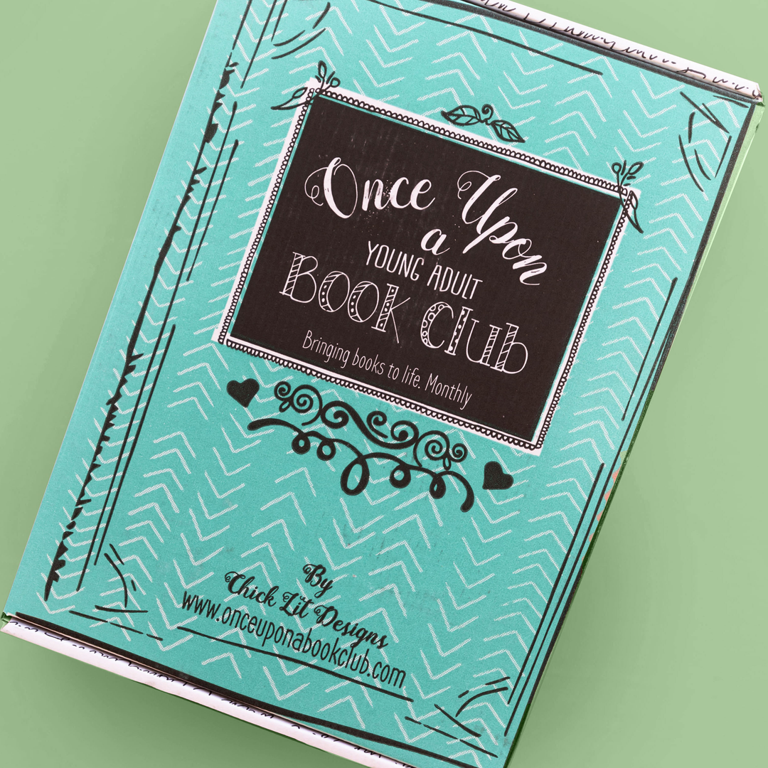 A teal "Once Upon a Young Adult Book Club" box with a decorative black label and white chevron patterns sits against a green background.