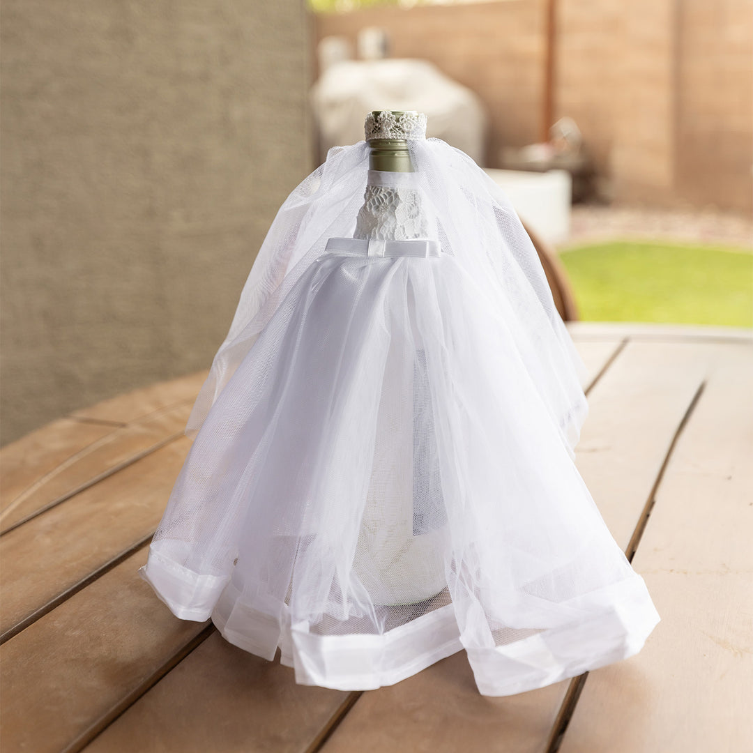 A white wedding dress wine bottle cover