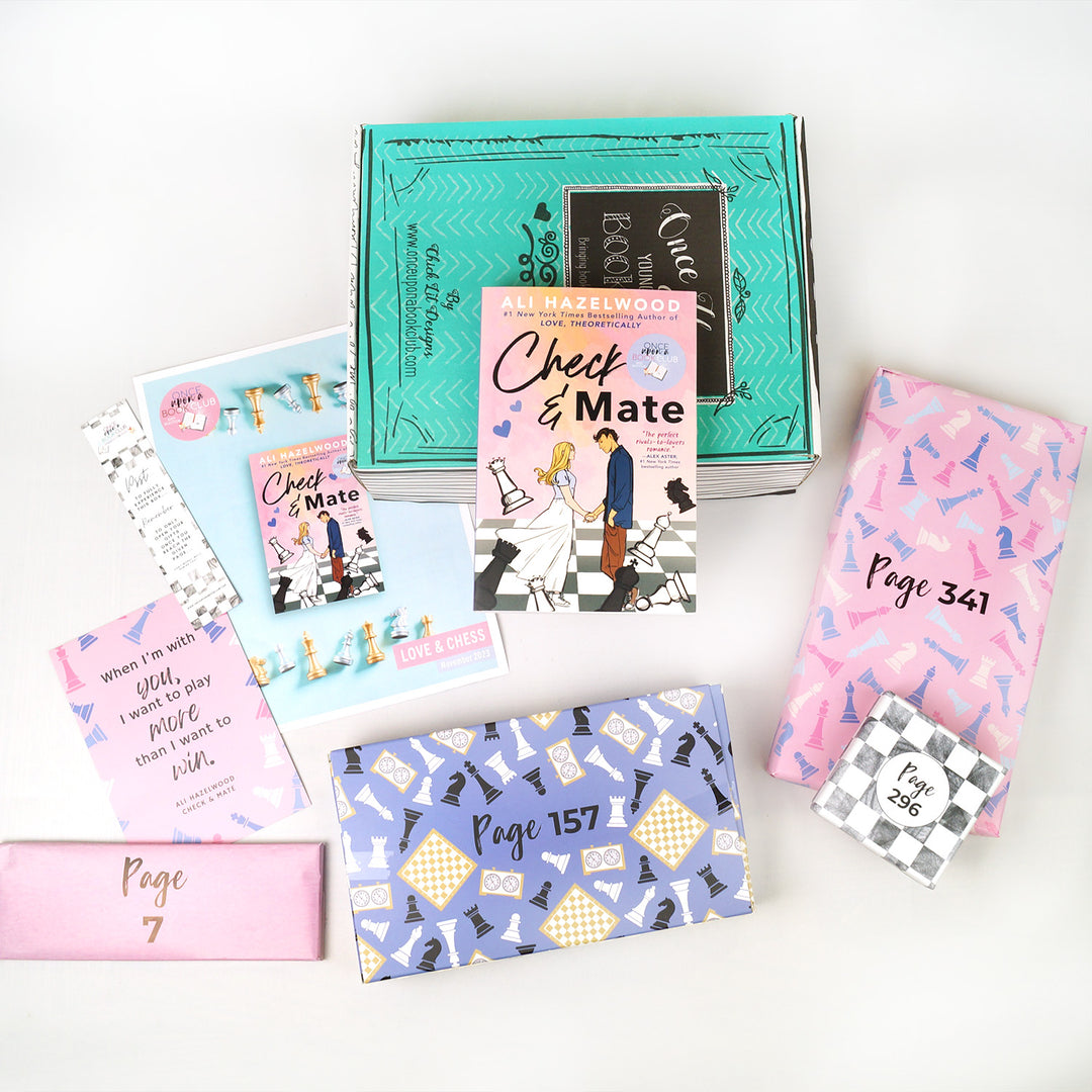 a paperback copy of Check & Mate lays against a green box. In front are a bookclub kit, bookmark, quote card, a light pink rectangular box, a rectangular box with chess pieces on it, a pink rectangular box with chess pieces on it, and a gray and white checkered square box. The boxes all have page numbers.