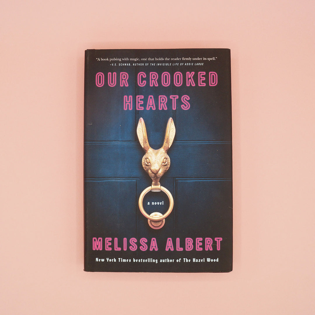 A hardcover copy of Our Crooked Hearts by Melissa Albert.