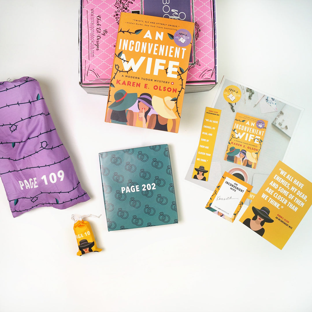 A hardcover edition of An Inconvenient Wife sits on top of a pink Once Upon a Book Club adult box. Surrounding this are three wrapped gifts labeled with page numbers, a signed bookplate, custom bookmark, art print, and monthly book club kit.