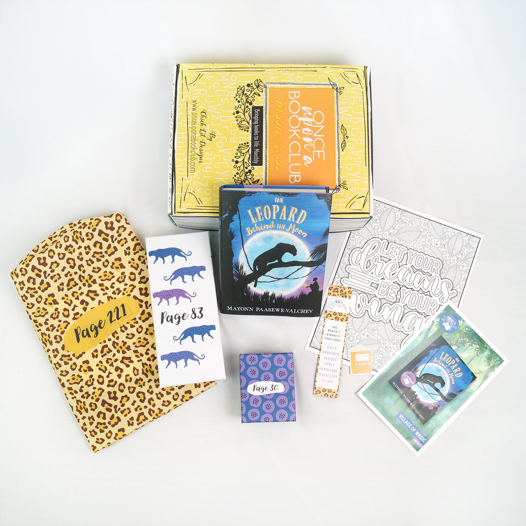 A hardcover edition of The Leopard Behind the Moon sits leaning against the front of a yellow box. In front are a leopard-patterned drawstring bag, a white rectangular box, a small square box, bookmark, book sticker, coloring page, and book flyer. The boxes and bags all have page numbers.
