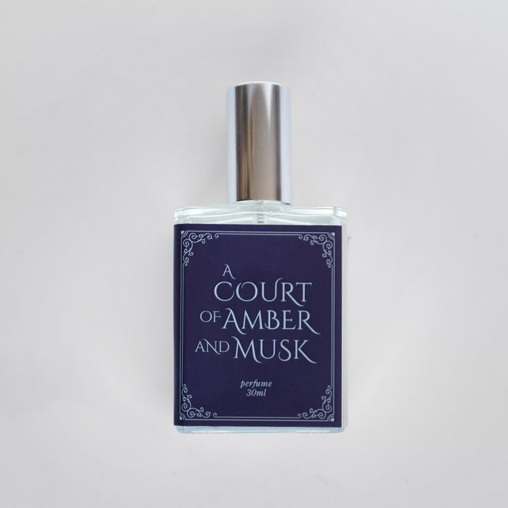 A closeup of the bottle containing the fragrance "A Court of Amber and Musk".