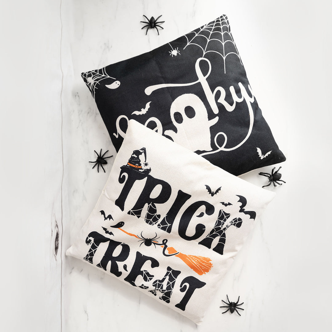 Halloween pillowcases with "Spooky" and "Trick or Treat" designs, accented with plastic spiders.