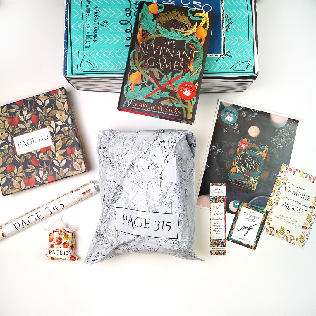 A hardcover copy of The Revenant Games by Margie Fuston sits on top of a green Once Upon a Book Club young adult box. Surrounding this are four wrapped gifts labeled with page numbers, a signed bookplate, custom bookmark, art print, and monthly book club kit.