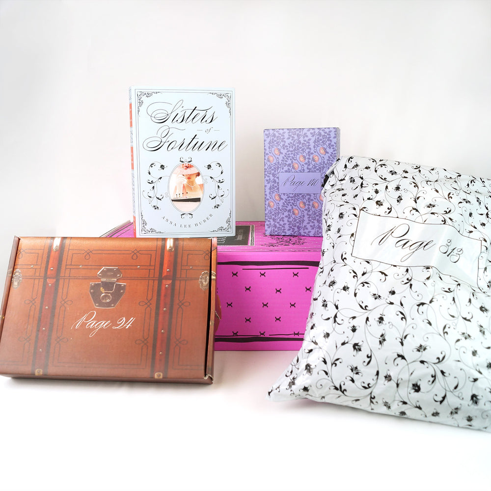 A custom, hardcover edition of Sisters of Fortune by Anna Lee Huber exclusively designed by Once Upon a Book Club sits on top of a pink Once Upon a Book Club Adult box. Surrounding this are three wrapped gifts labeled with page numbers