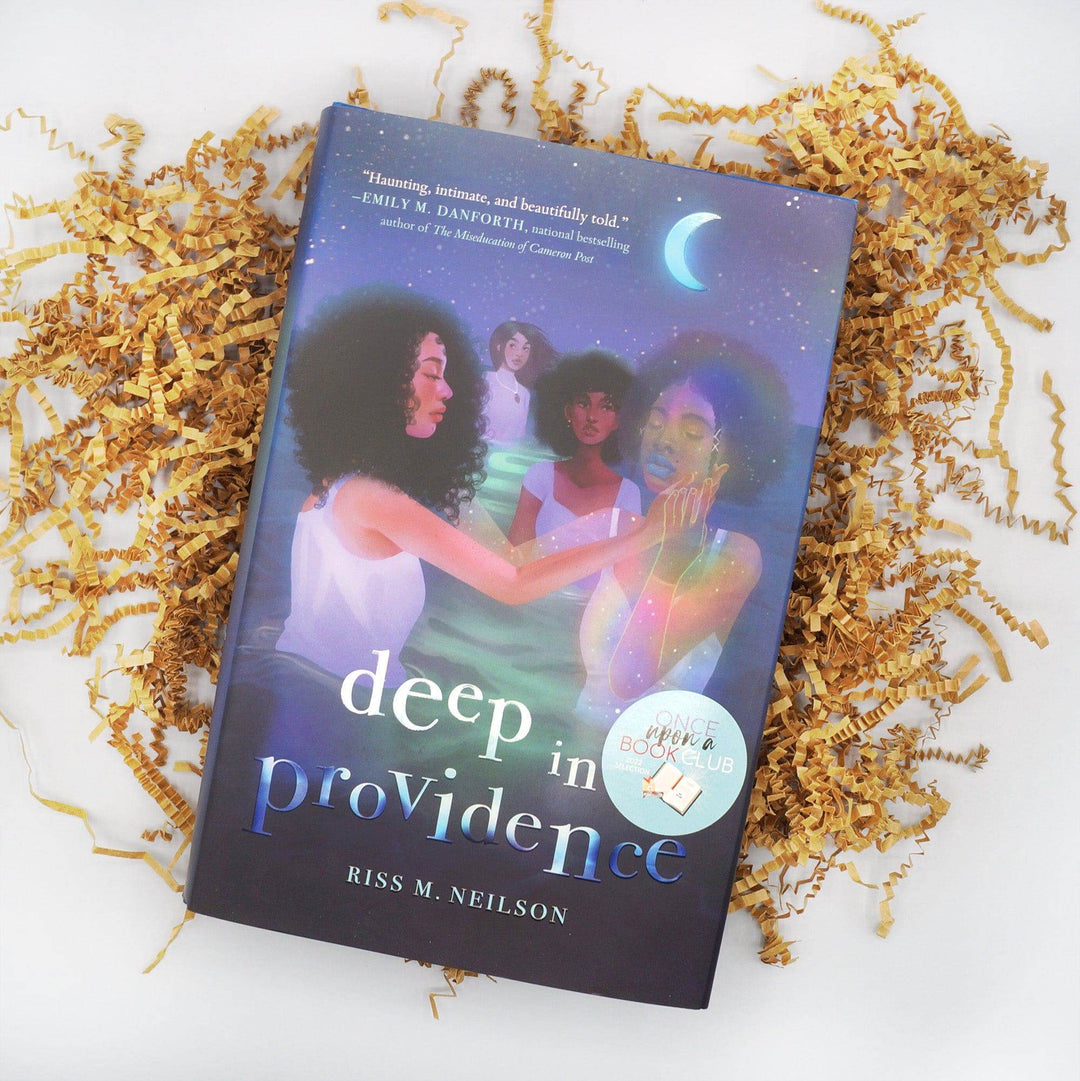 A hardcover edition of Deep in Providence by Riss M Neilson laying on brown crinkle paper