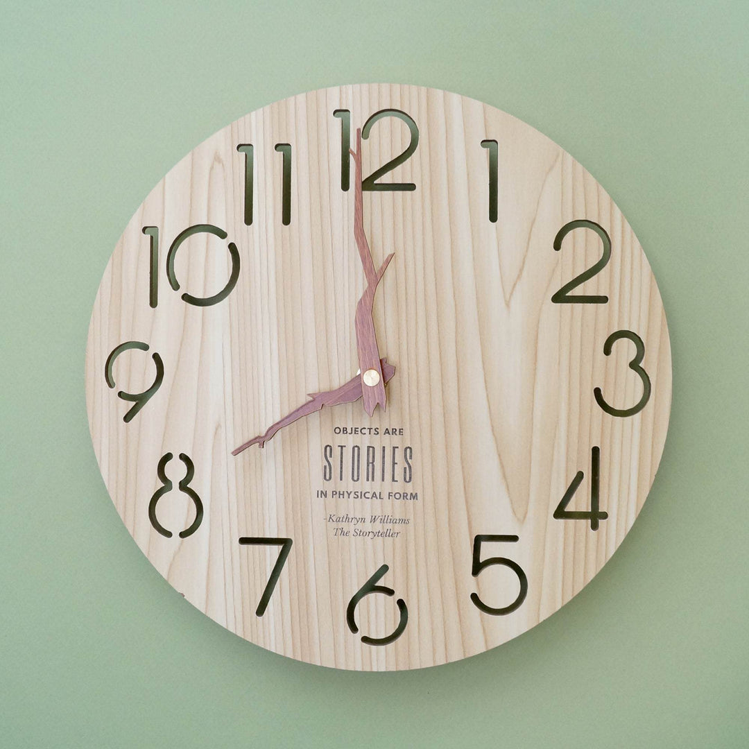 a wooden wall clock with the quote "Objects are stories in physical form"