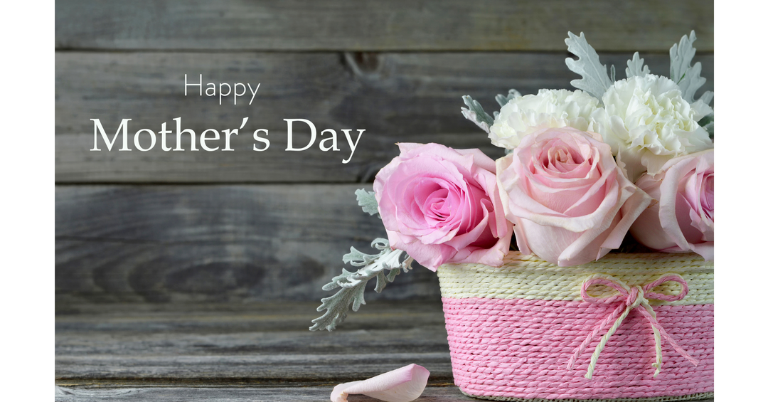 Mother’s Day floral arrangement with pink roses in a woven basket and “Happy Mother’s Day” text on a wooden background.