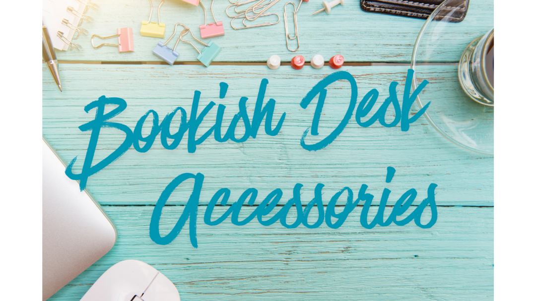 Flat lay of a turquoise wooden desk with pastel binder clips, paper clips, a keyboard, mouse, and bold teal text reading “Bookish Desk Accessories.”