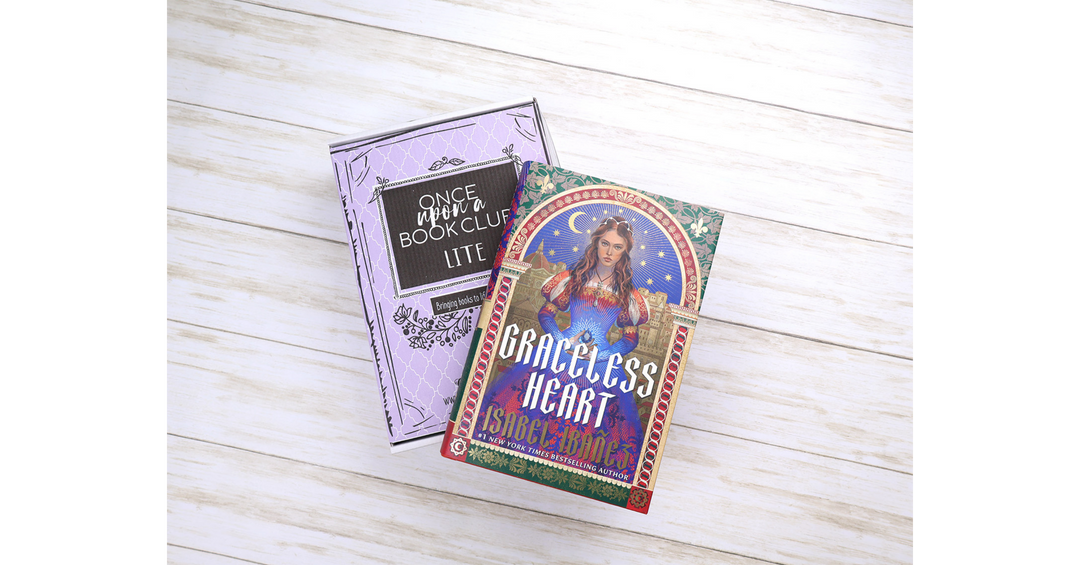 Once Upon a Book Club Lite box styled beside Graceless Heart by Isabel Ibañez on a light wooden background.