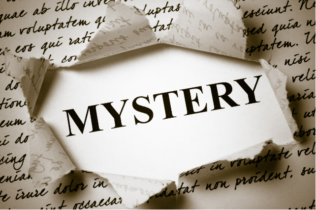 The word 'Mystery' is written in the center of a torn newspaper.