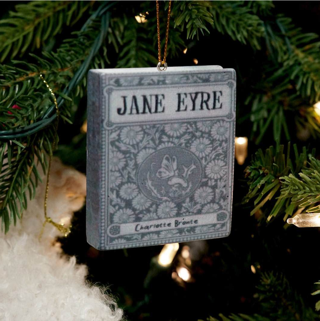 A book "JANE EYRE" is hanging in front of a tree