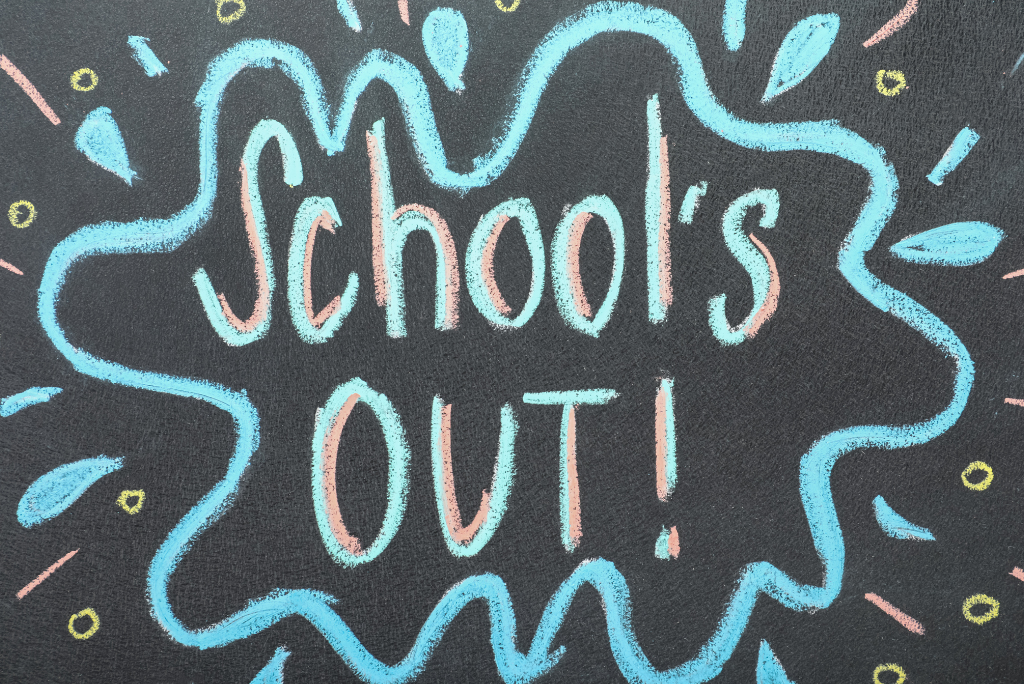 Colorful chalkboard-style drawing with the phrase “School’s Out!” surrounded by fun doodles and bursts in pastel blue, pink, and yellow.
