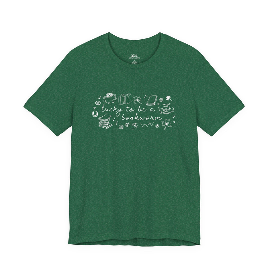 Green t-shirt with white font reading "lucky to be a bookworm" and line illustrations of St. Patrick's Day items and books on a white background