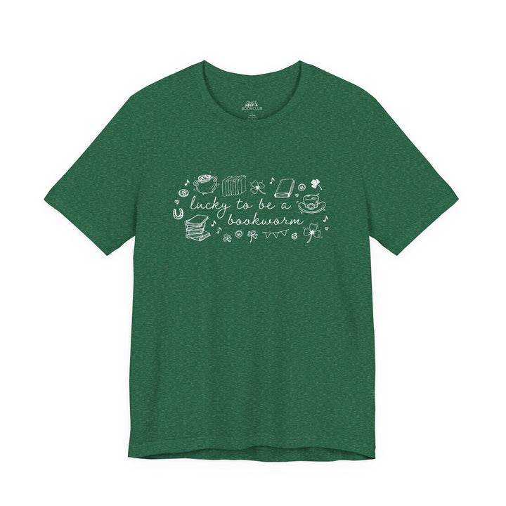 Green t-shirt with white font reading "lucky to be a bookworm" and line illustrations of St. Patrick's Day items and books on a white background
