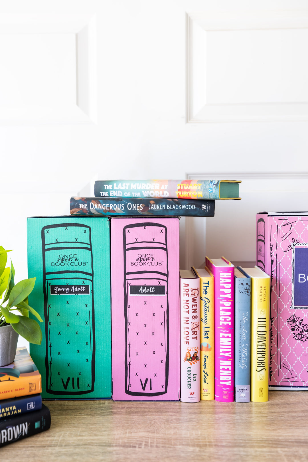 Stack of books with colorful covers on a wooden surface