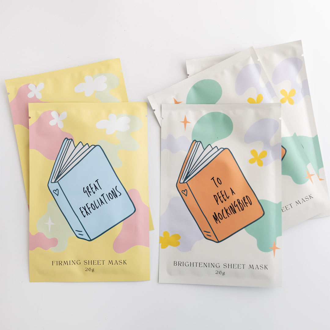 A set of five sheet face masks with a book on the front of each one. The two on the left are yellow with the book 'Great Exfoliations' firming sheet mask. The three on the right are white with the book 'To Peel a Mockingbird' brightening sheet mask.