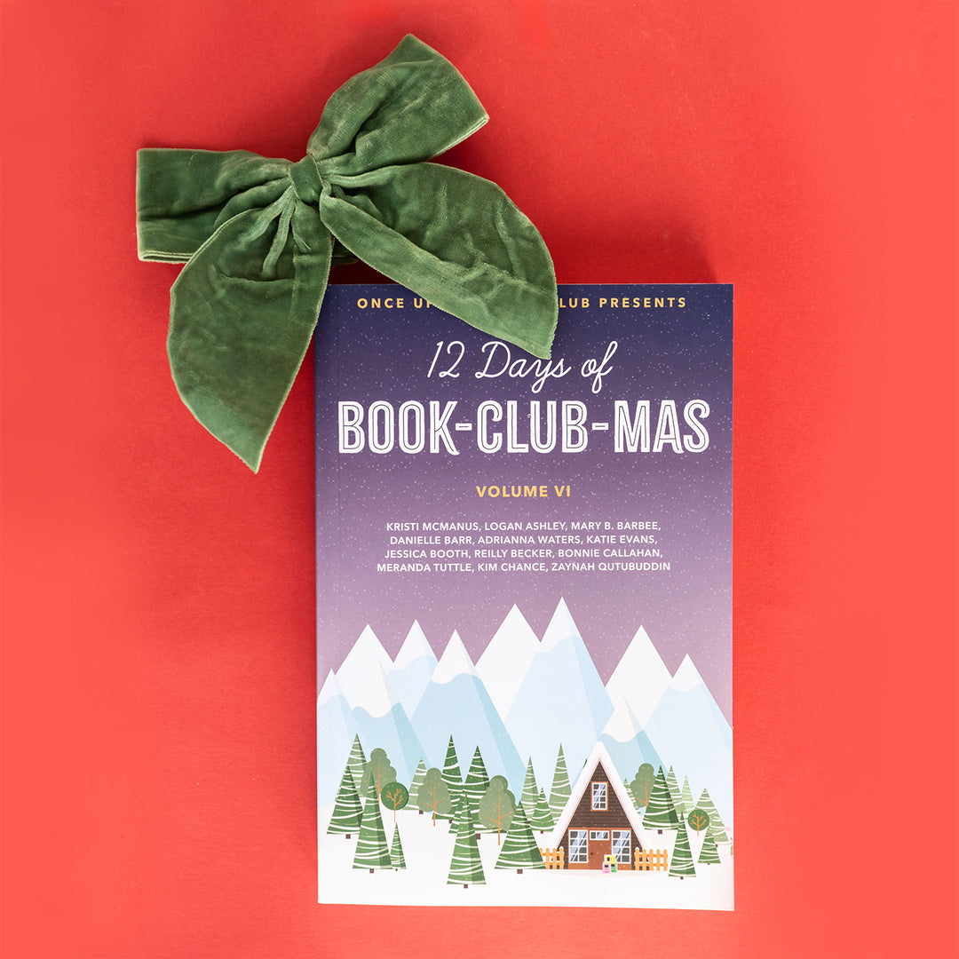 paperback copy of 12 Days of Book-Club-Mas 2023 Novella with a green felt box on top sits on a red background