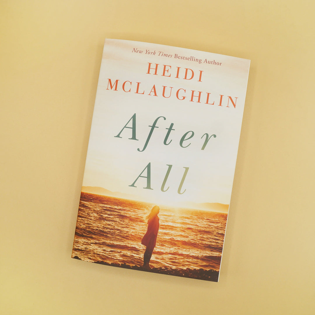 A paperback copy of After All by Heidi McLaughlin.