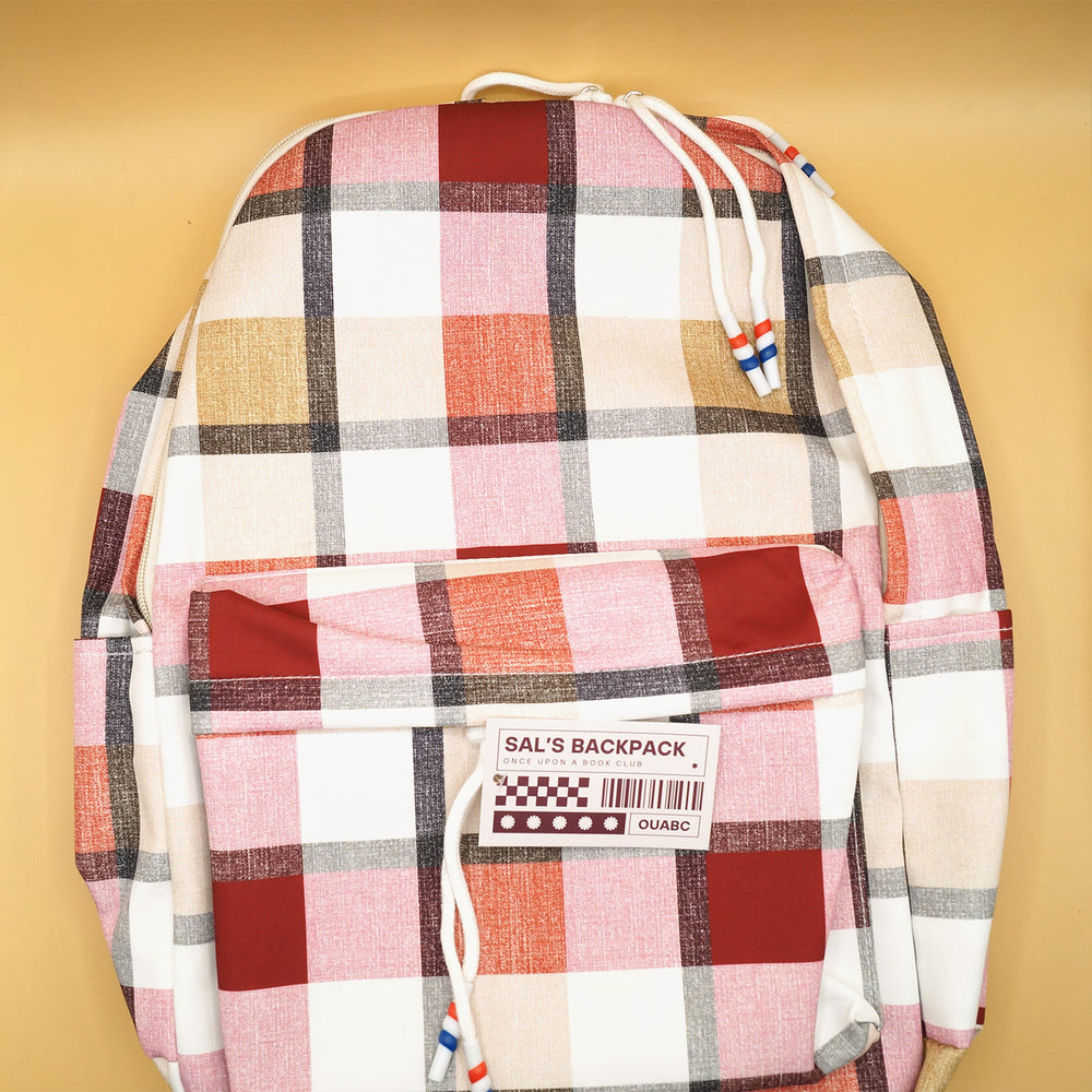 A gingham patterned backpack featuring pinks, whites, reds, and grays