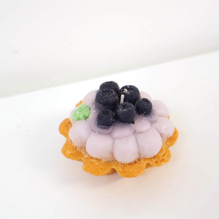 a candle in the shape of a berry tart.