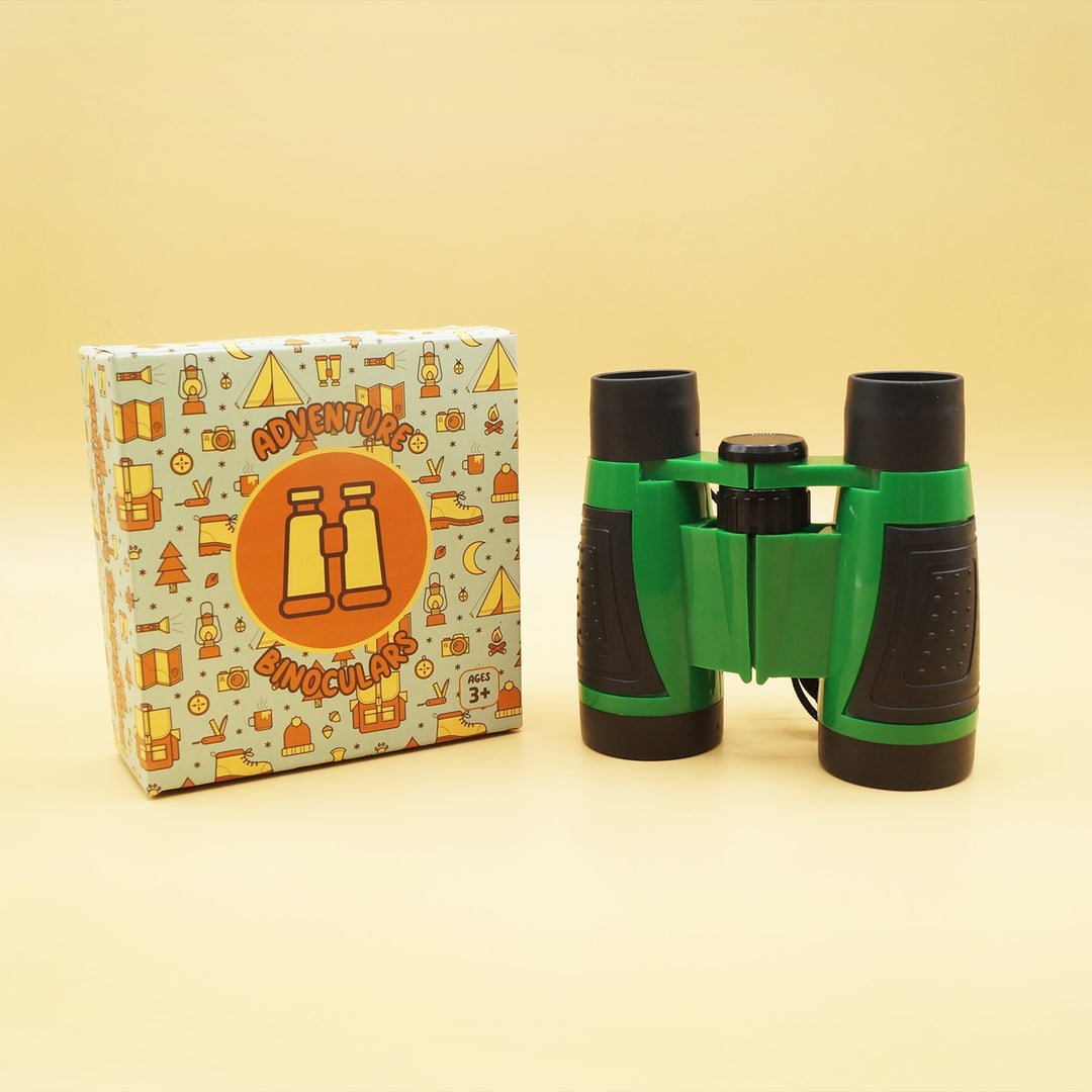 a set of green and black binoculars sit next to a box labeled Adventure Binoculars