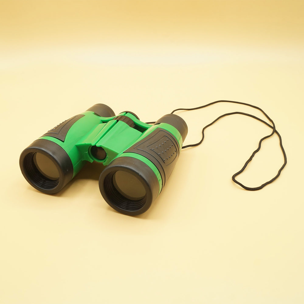 a set of green and black binoculars sit on a yellow background
