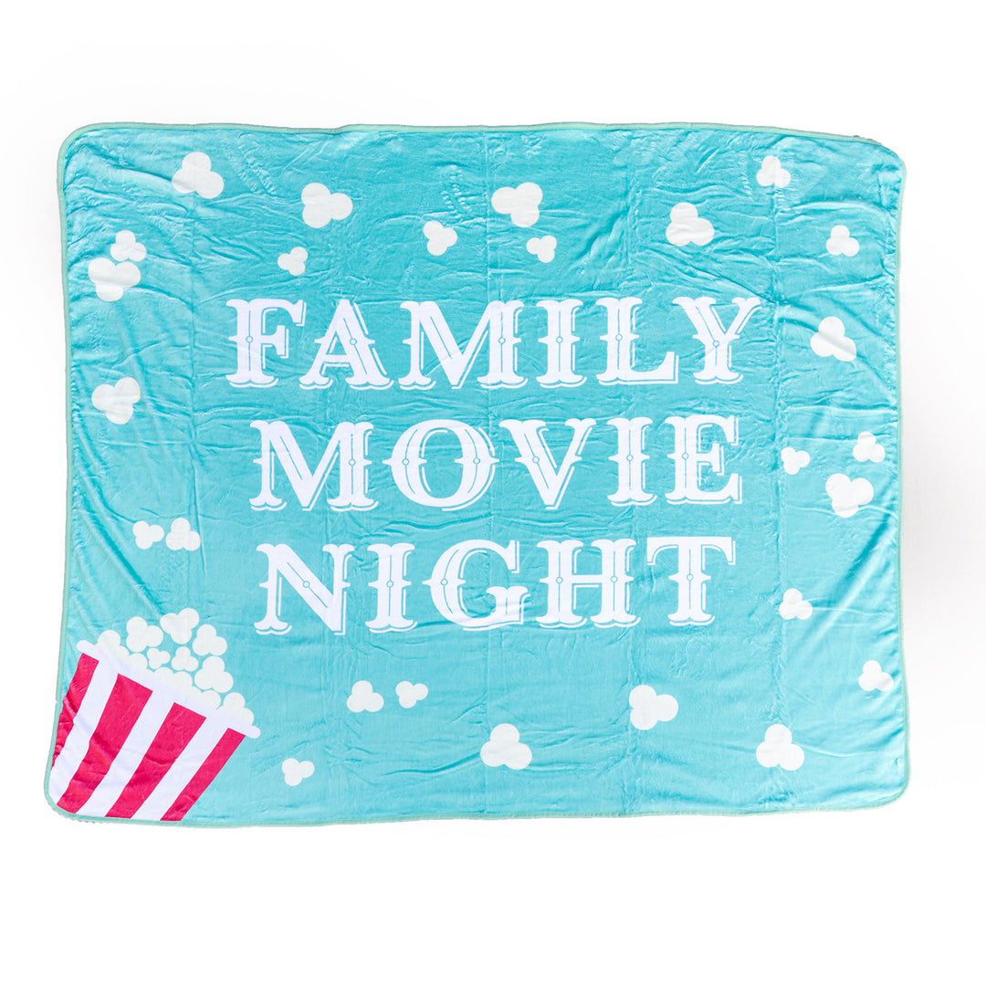 A square light blue blanket with a popcorn pattern and the words Family Movie Night