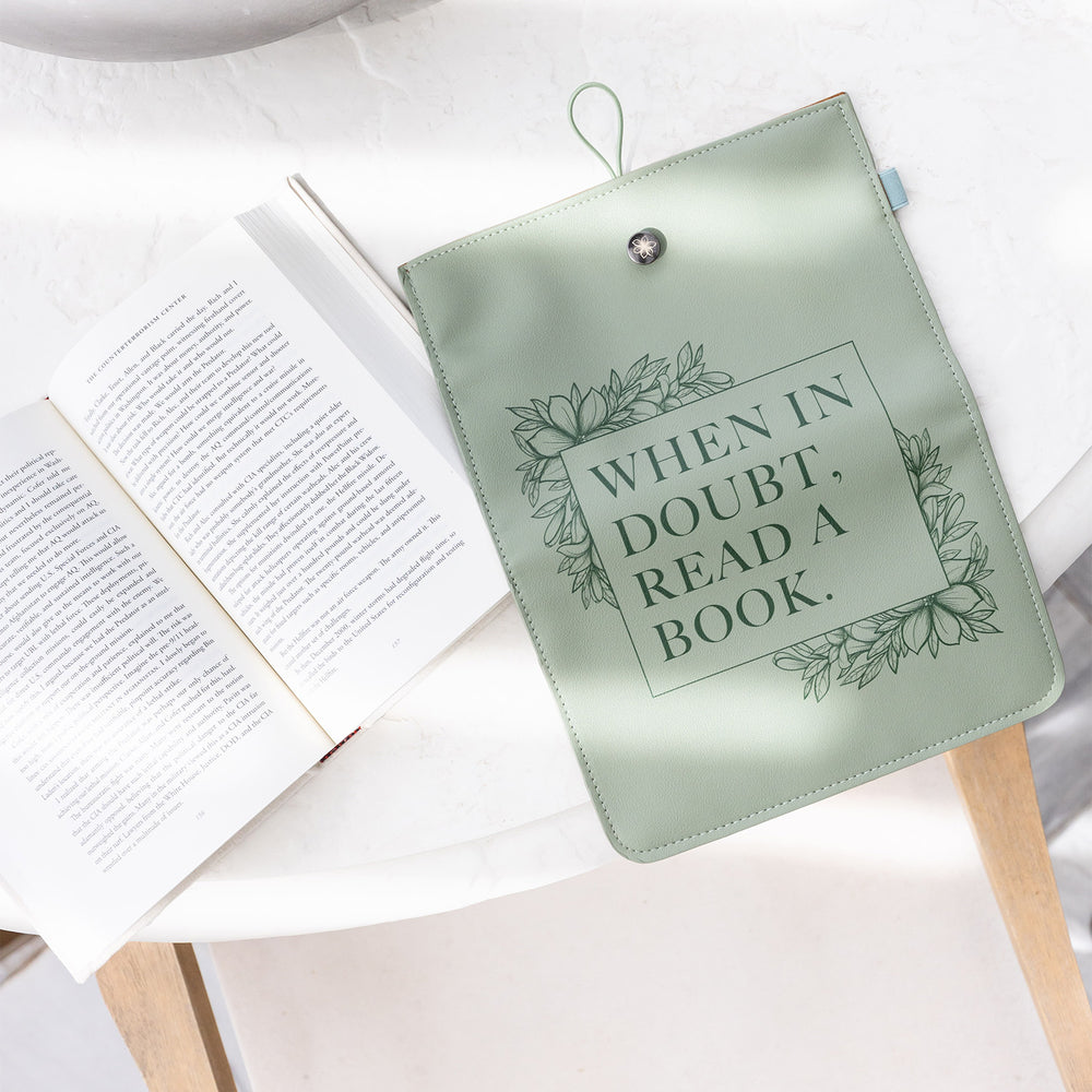 The "When in Doubt" booksleeve sits on a table next to an open book.