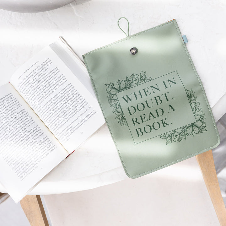 The "When in Doubt" booksleeve sits on a table next to an open book.