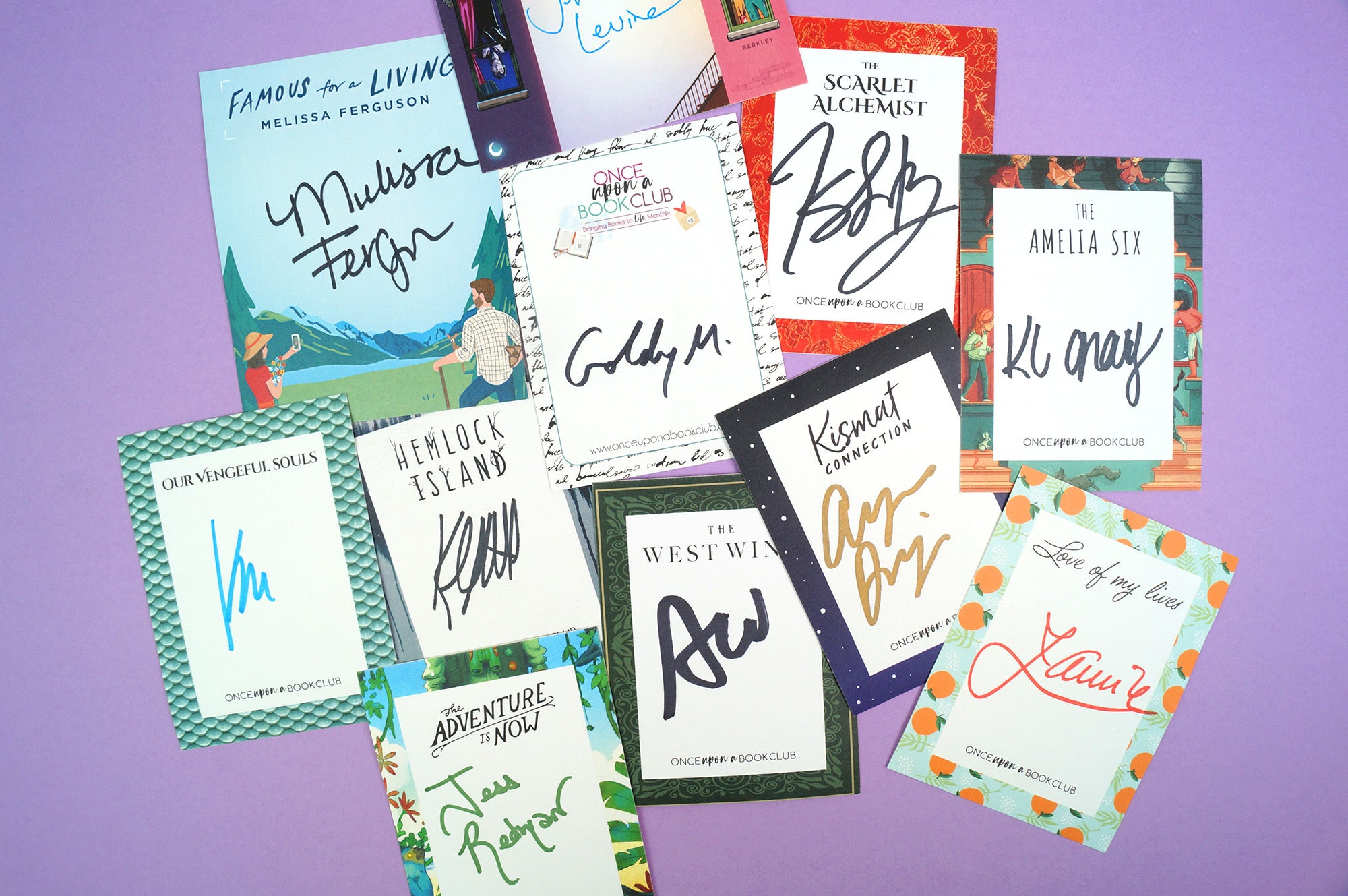 a pile of varying signature cards lays against a purple background