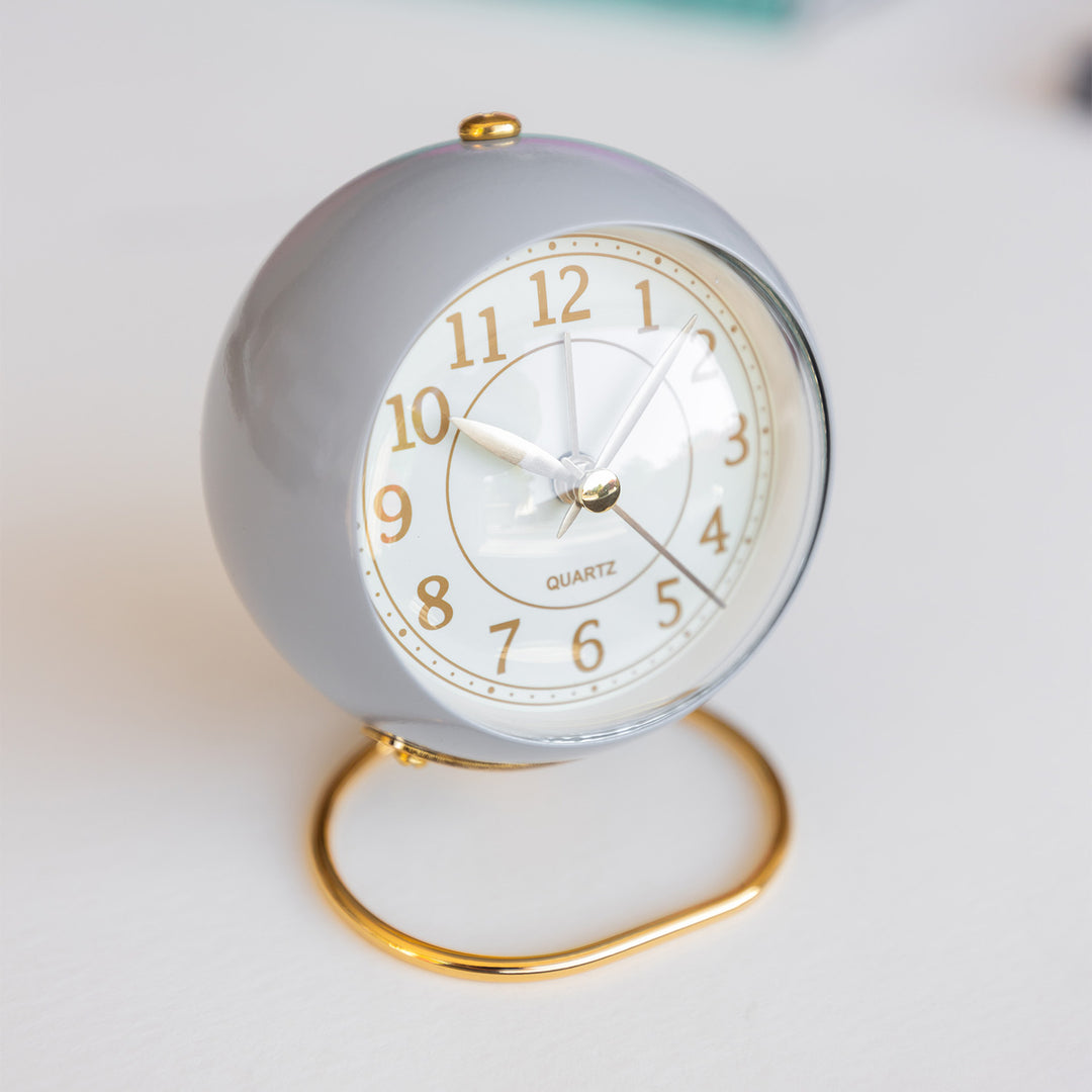 A light purple and gold alarm clock