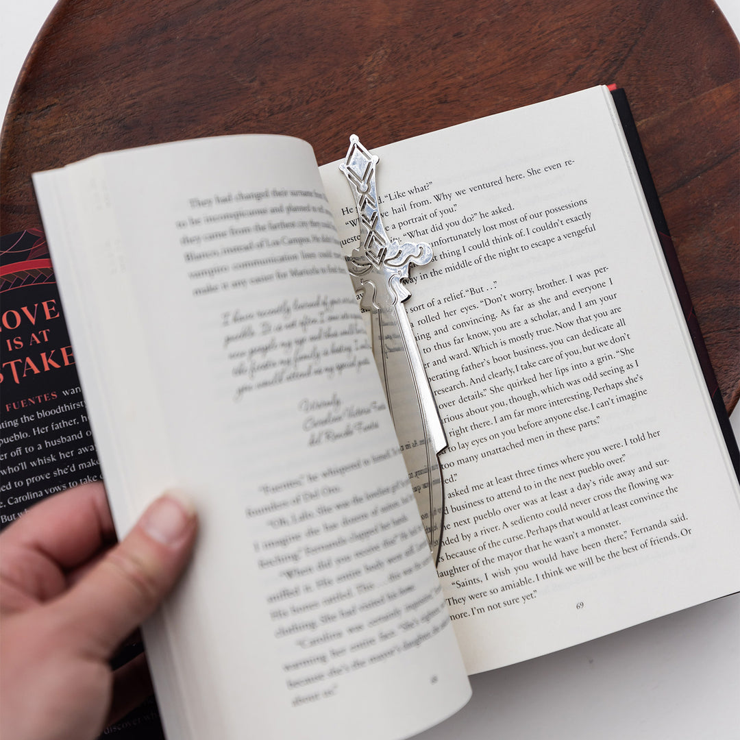 A silver metal dagger bookmark.