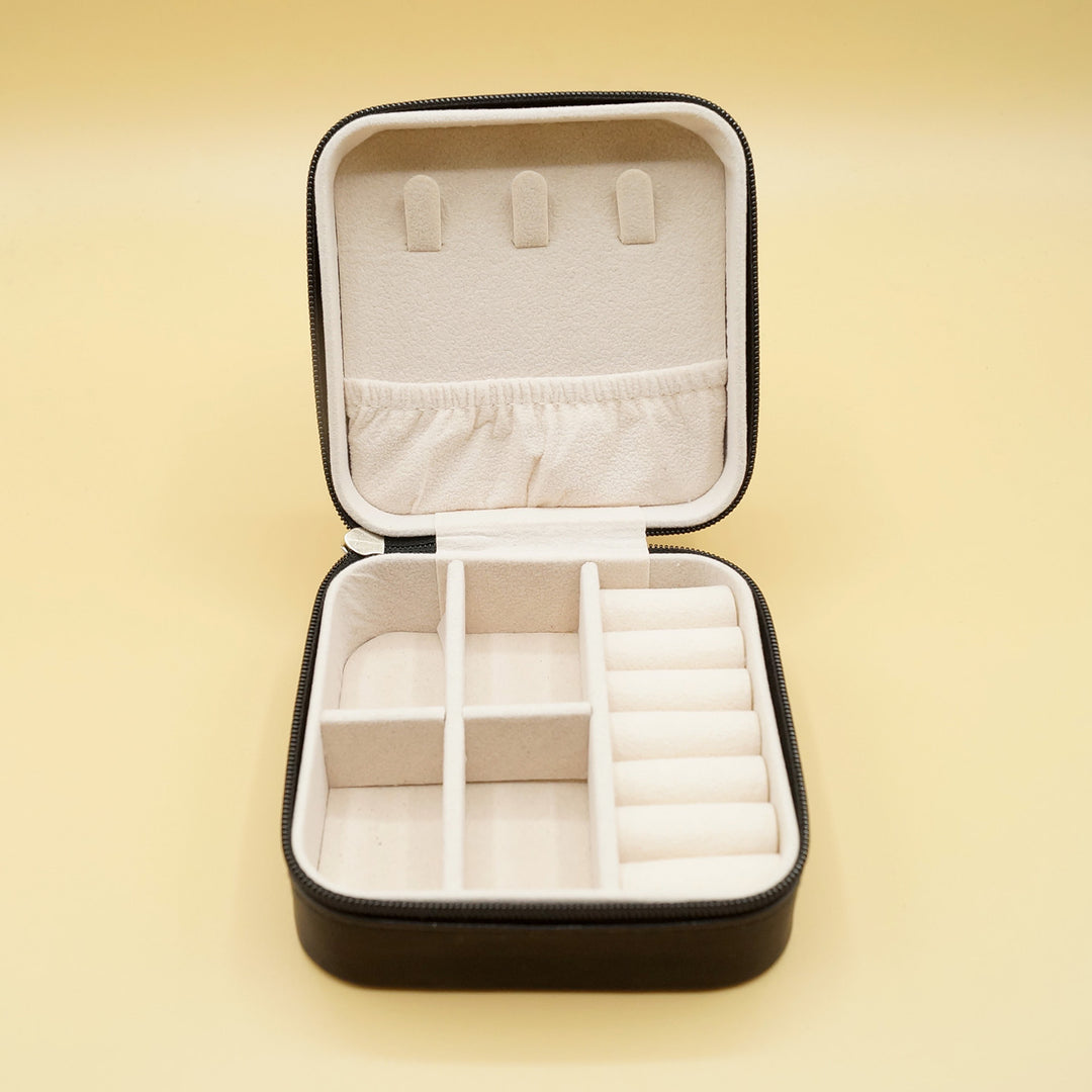 an open black travel jewelry box with white inside