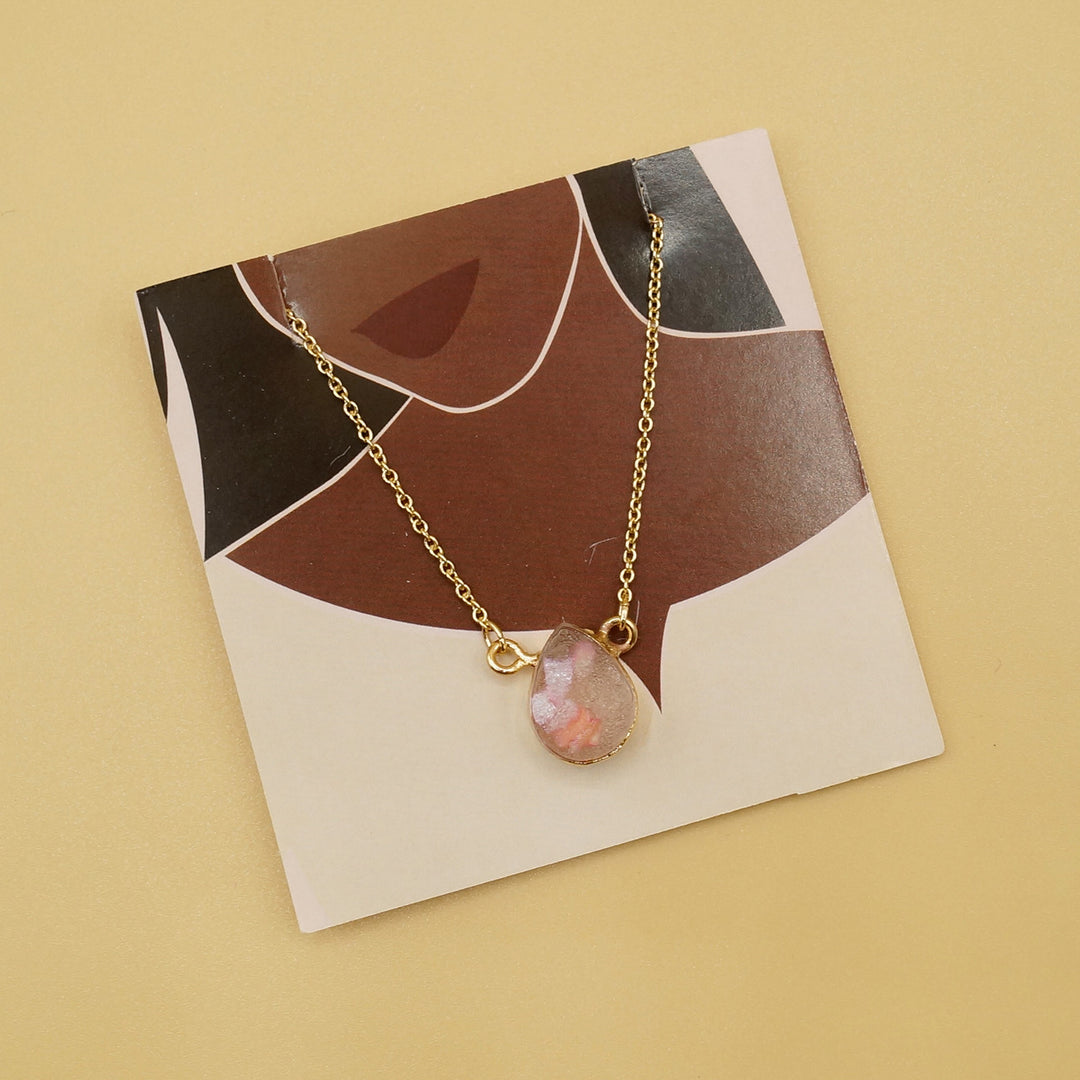 an opal necklace with gold chain