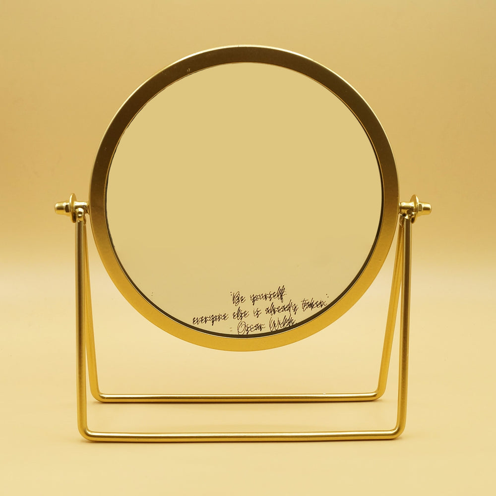 a vanity mirror with gold trim. On the bottom of the mirror is the quote "Be Yourself, everyone else is already taken" - Oscar Wilde 
