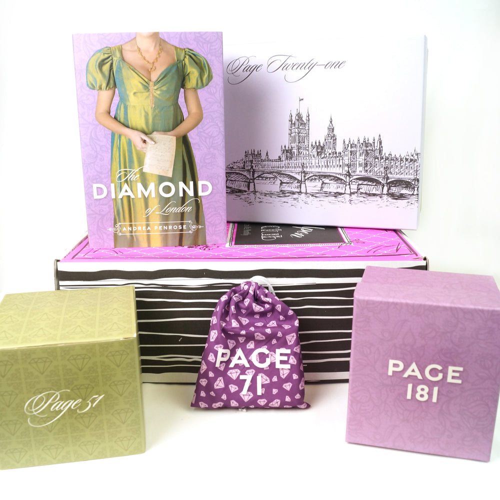 A pink box lays on a white background. On top of the box is a hardcover, exclusive edition of THE DIAMOND OF LONDON by Andrea Penrose. Around the book and box are four wrapped packages labeled with page numbers meant only to be opened as you read the included book and reach the specified pages. All packaging features regency-inspired designs.