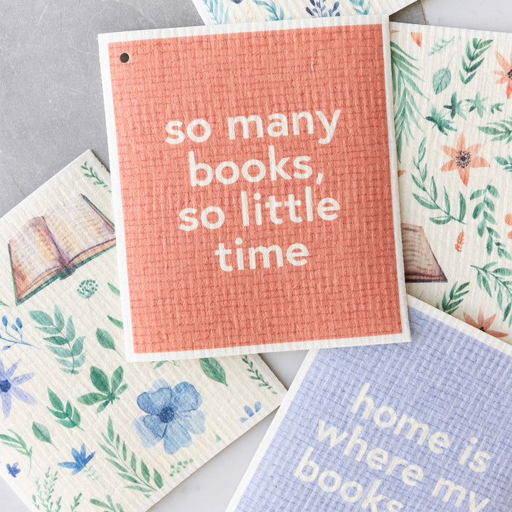 A collection of Swedish dishcloths in pastel tones featuring flowers and books.
