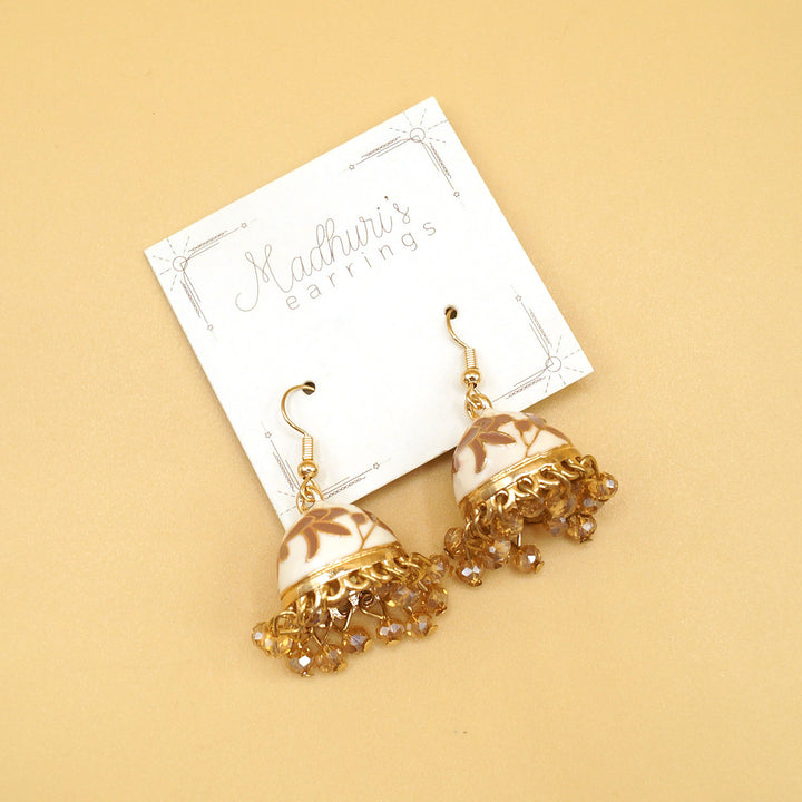 a pair of gold, white, and brown Jhumka Earrings 