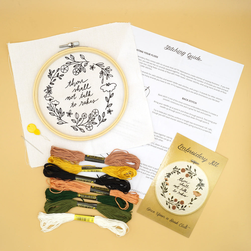 The embroidery kit components, including the hoop, fabric with printed pattern, needle, 7 colors of embroidery floss, and written instructions for the stitches needed to complete the project.