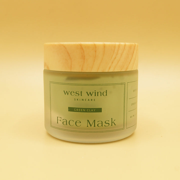 a green clay face mask in a container with a wooden lid