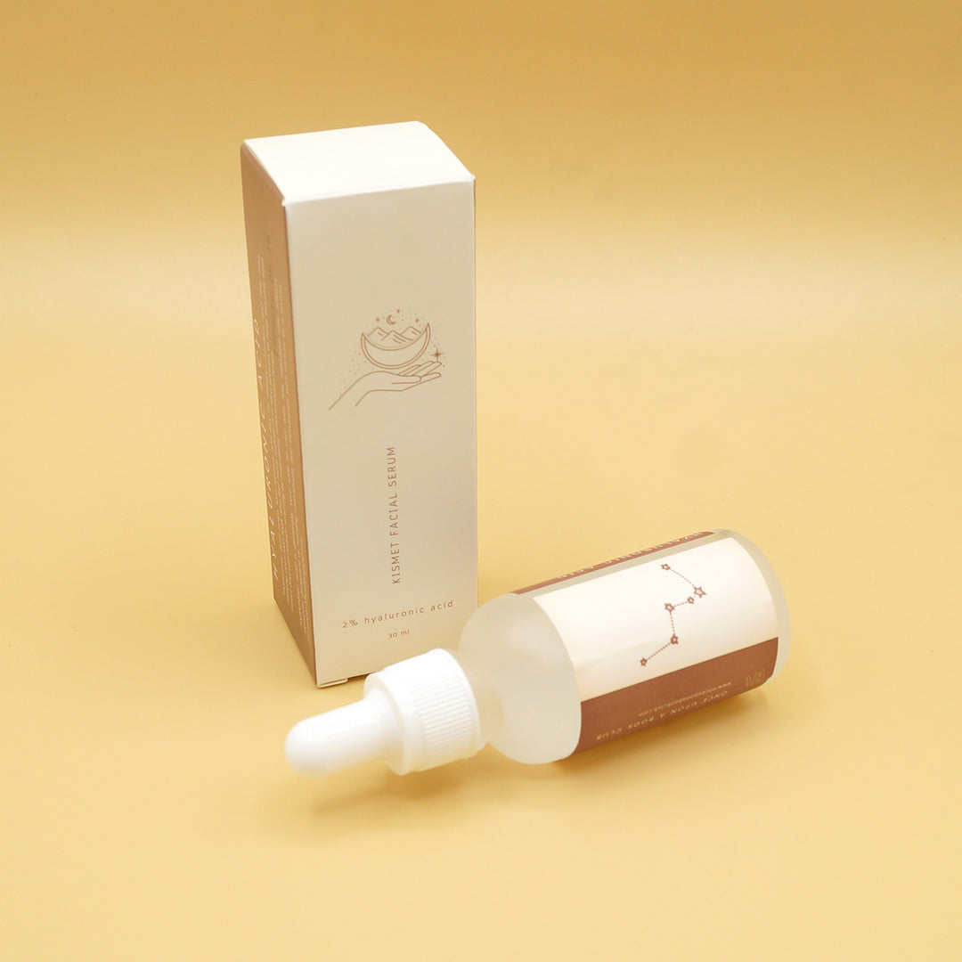 a white box with a tube of hyaluronic acid face serum in front of it on its side
