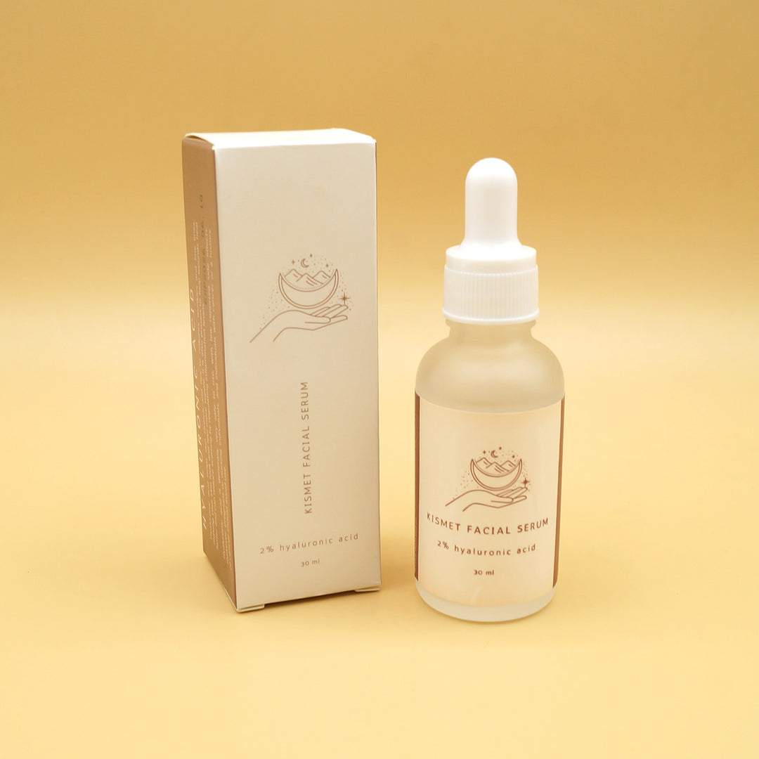 a white box with a tube of hyaluronic acid face serum next to it