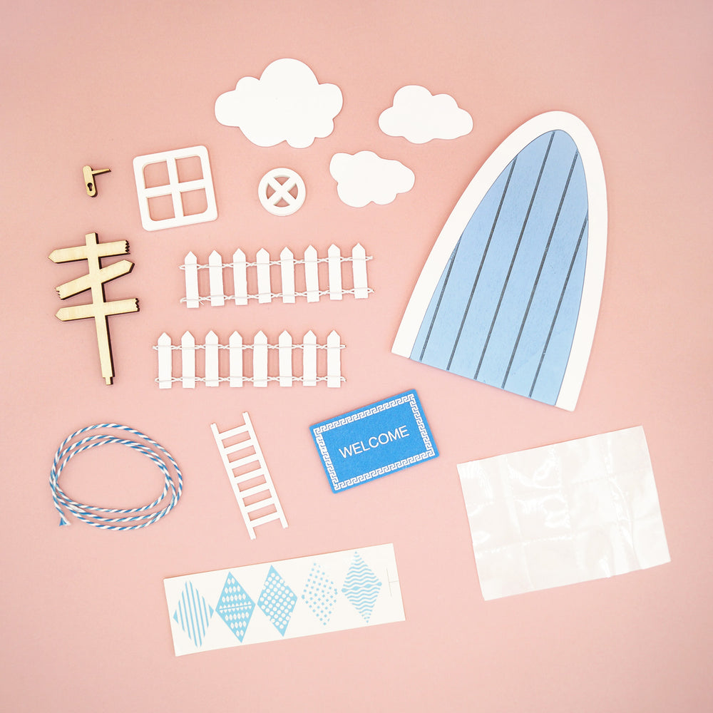 Set of miniature garden accessories including a gate, fence, clouds, and a 'Welcome' sign on a pink background.