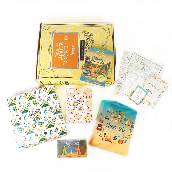 A paperback edition of The Firefly Summer stands on a yellow OUABC box. In front of the box are four themed wrapped gifts labeled with page numbers. Each gift has summer-themed wrapping paper.