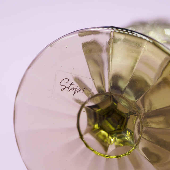 the bottom of the goblet showing the small sticker with the word "Stop!" written on it.